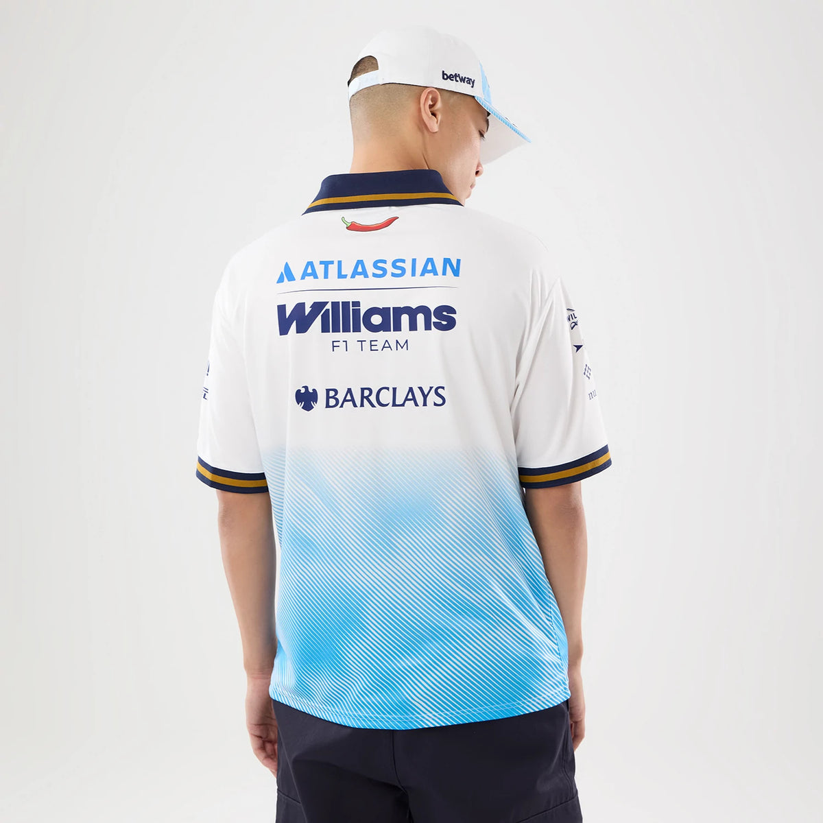 New Era Williams Spain Race Special White T-Shirt, back view on a model with a white cap, prominently displaying the Atlassian and Barclays logos, a Williams F1 Team logo across the upper back.