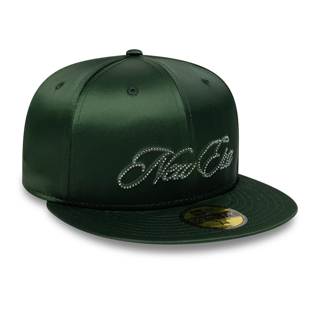 New Era Satin Diamante Dark Green 59FIFTY Fitted Cap, three-quarter view showing the New Era script in diamante detail on the front panel, a flat dark green visor, and a gold 59FIFTY size sticker on the top of the visor.