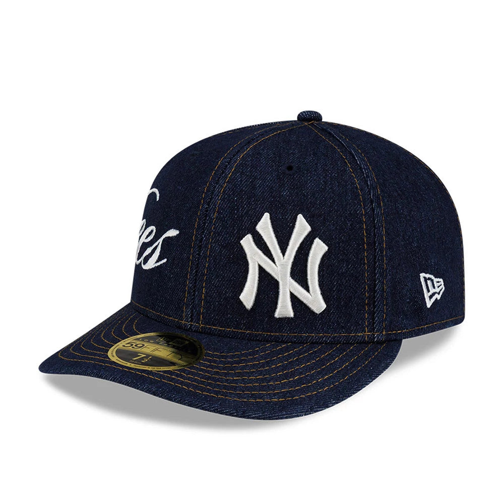 New York Yankees MLB Denim Navy Low Profile New Era 59FIFTY Fitted Cap, three-quarter view showing the raised white embroidered NY logo on the front panel, navy denim visor with gold 59FIFTY size sticker, and New Era flag logo on the left side.