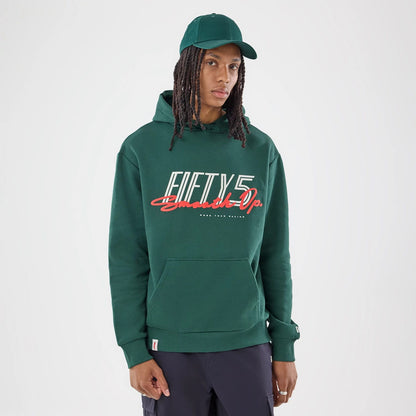 The model is wearing this Carlos Sainz Team Fifty5 Smooth Oversized Pullover Hoodie in dark green. 1