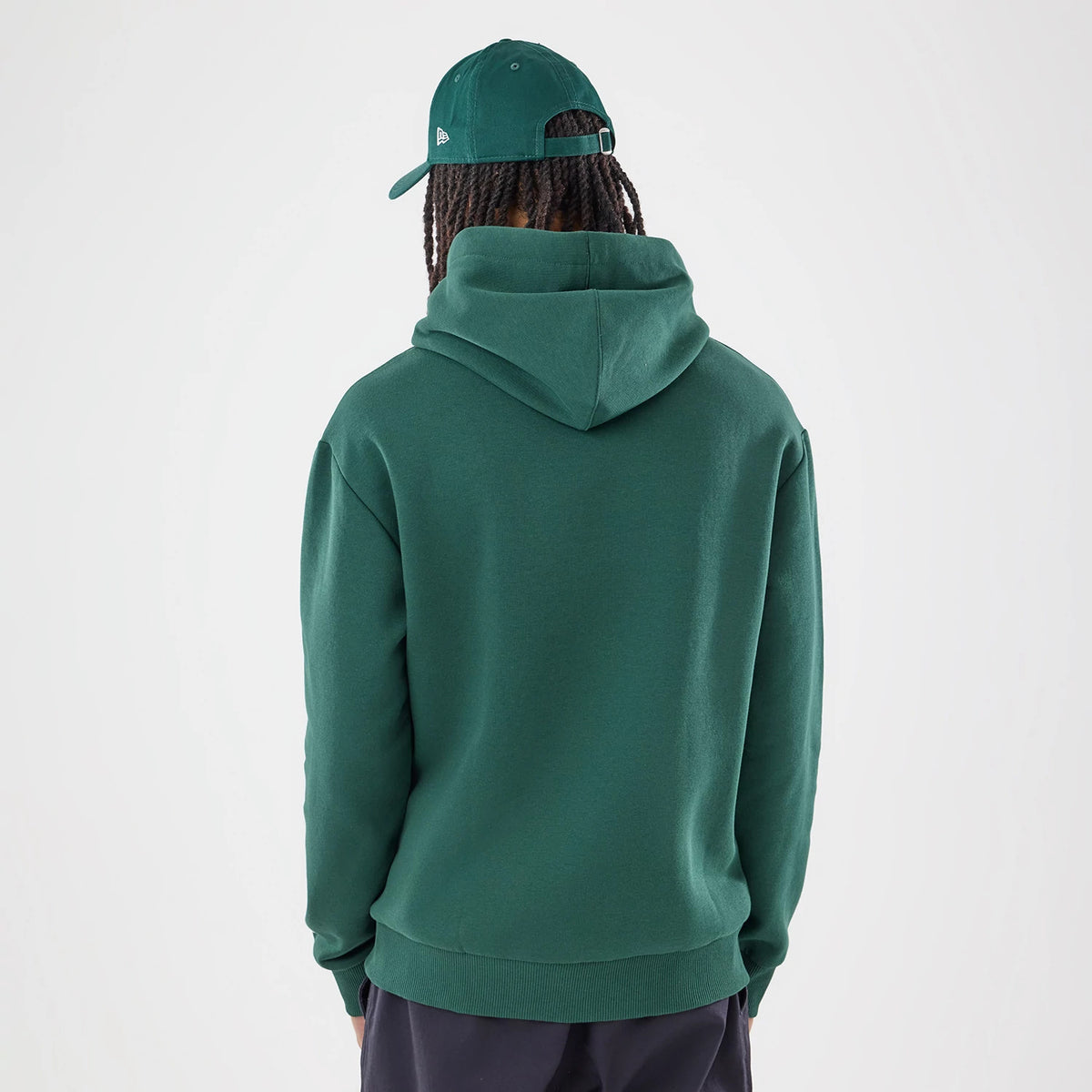 The model is wearing this Carlos Sainz Team Fifty5 Smooth Oversized Pullover Hoodie in dark green. 2
