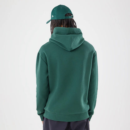 The model is wearing this Carlos Sainz Team Fifty5 Smooth Oversized Pullover Hoodie in dark green. 2