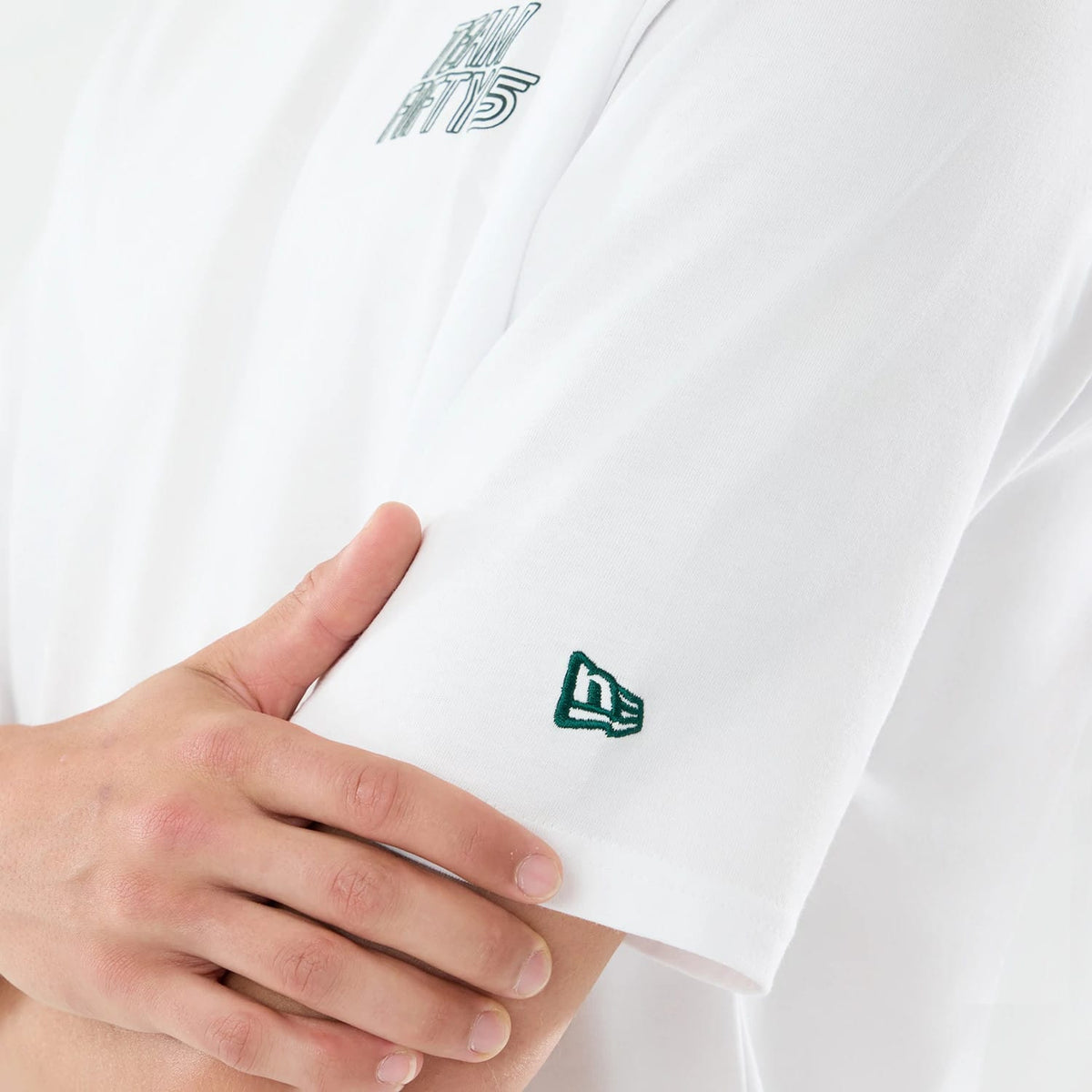 The model is wearing this Carlos Sainz Team Fifty5 Mexico Oversized T-Shirt in white. 3