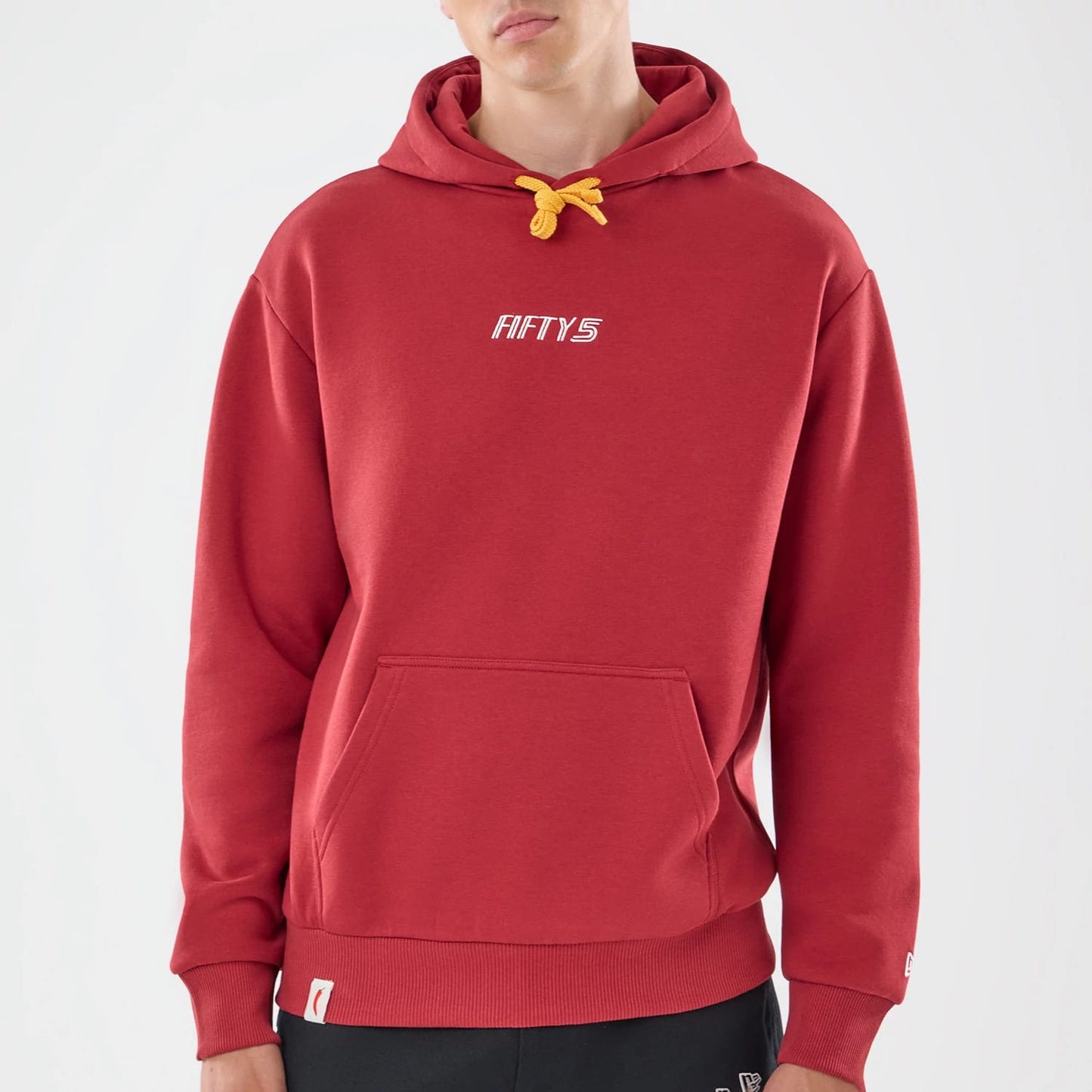 The model is wearing this Carlos Sainz Team Fifty5 Madrid Oversized Pullover Hoodie in dark red. 3