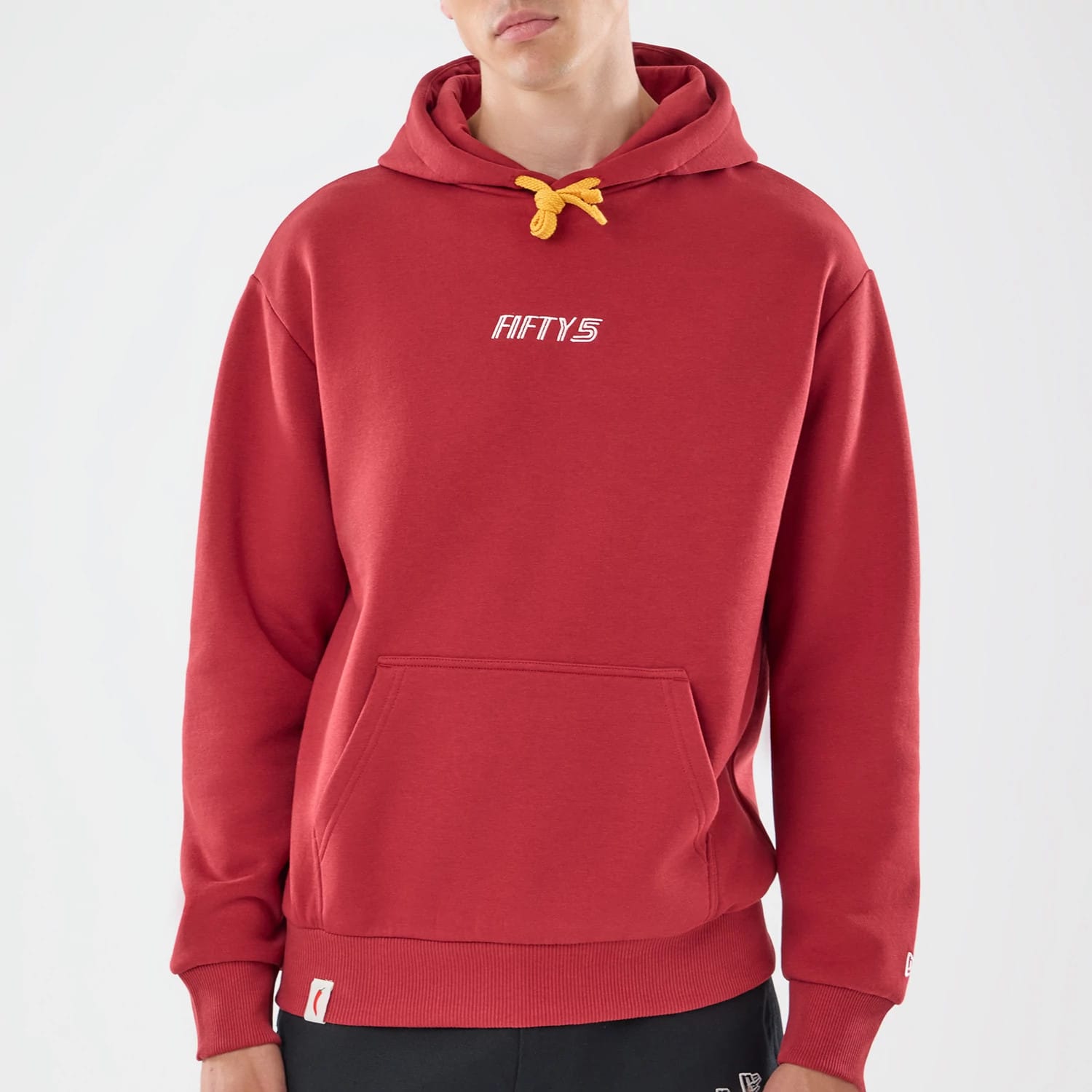 The model is wearing this Carlos Sainz Team Fifty5 Madrid Oversized Pullover Hoodie in dark red. 3
