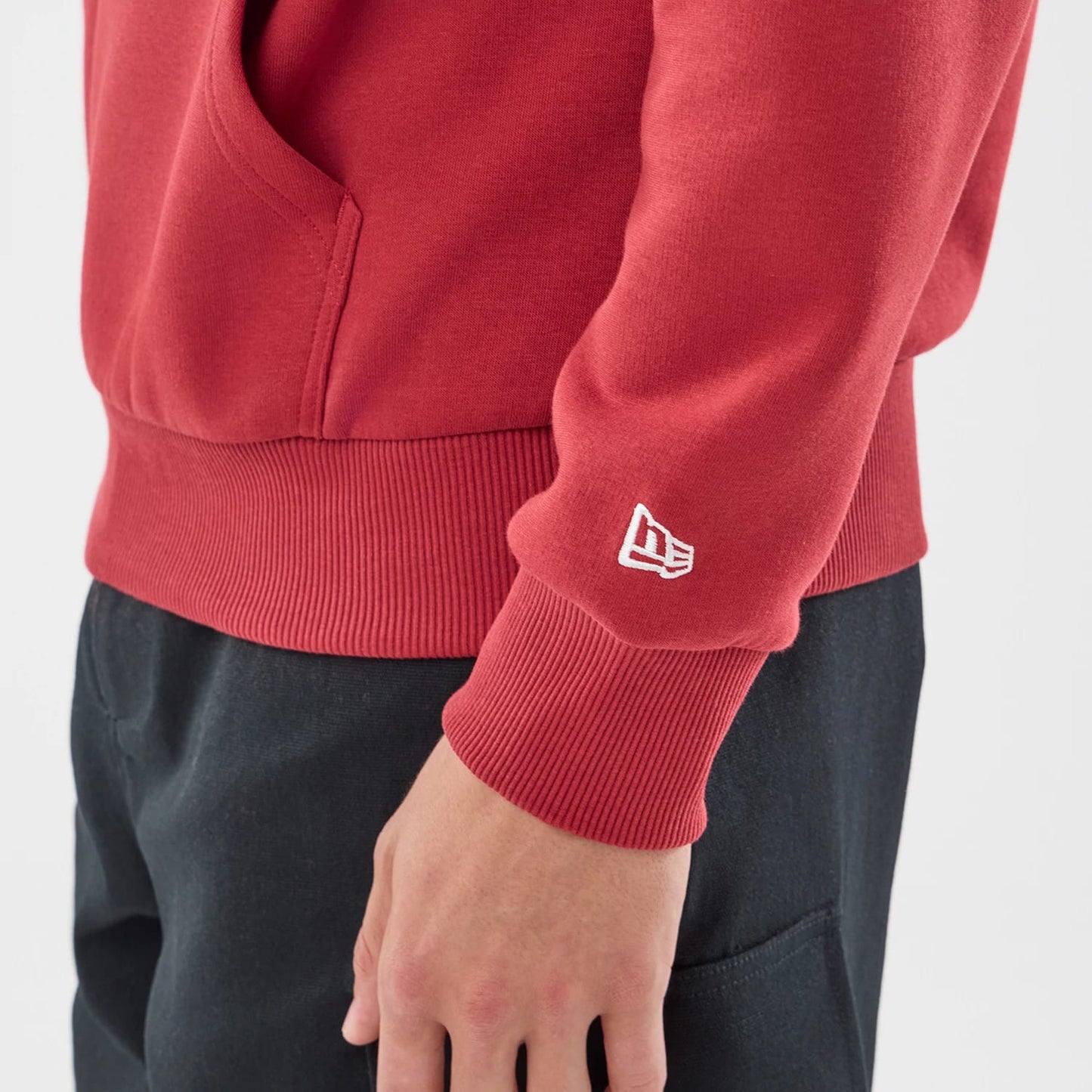 The model is wearing this Carlos Sainz Team Fifty5 Madrid Oversized Pullover Hoodie in dark red. 5