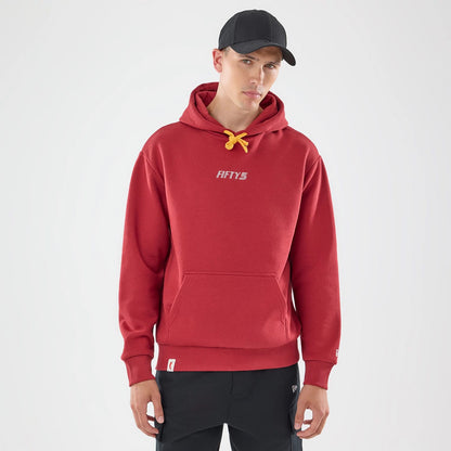 The model is wearing this Carlos Sainz Team Fifty5 Madrid Oversized Pullover Hoodie in dark red. 1
