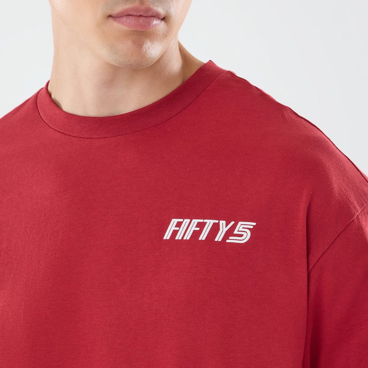 The model is wearing this Carlos Sainz Team Fifty5 Madrid Oversized T-Shirt in dark red. 4