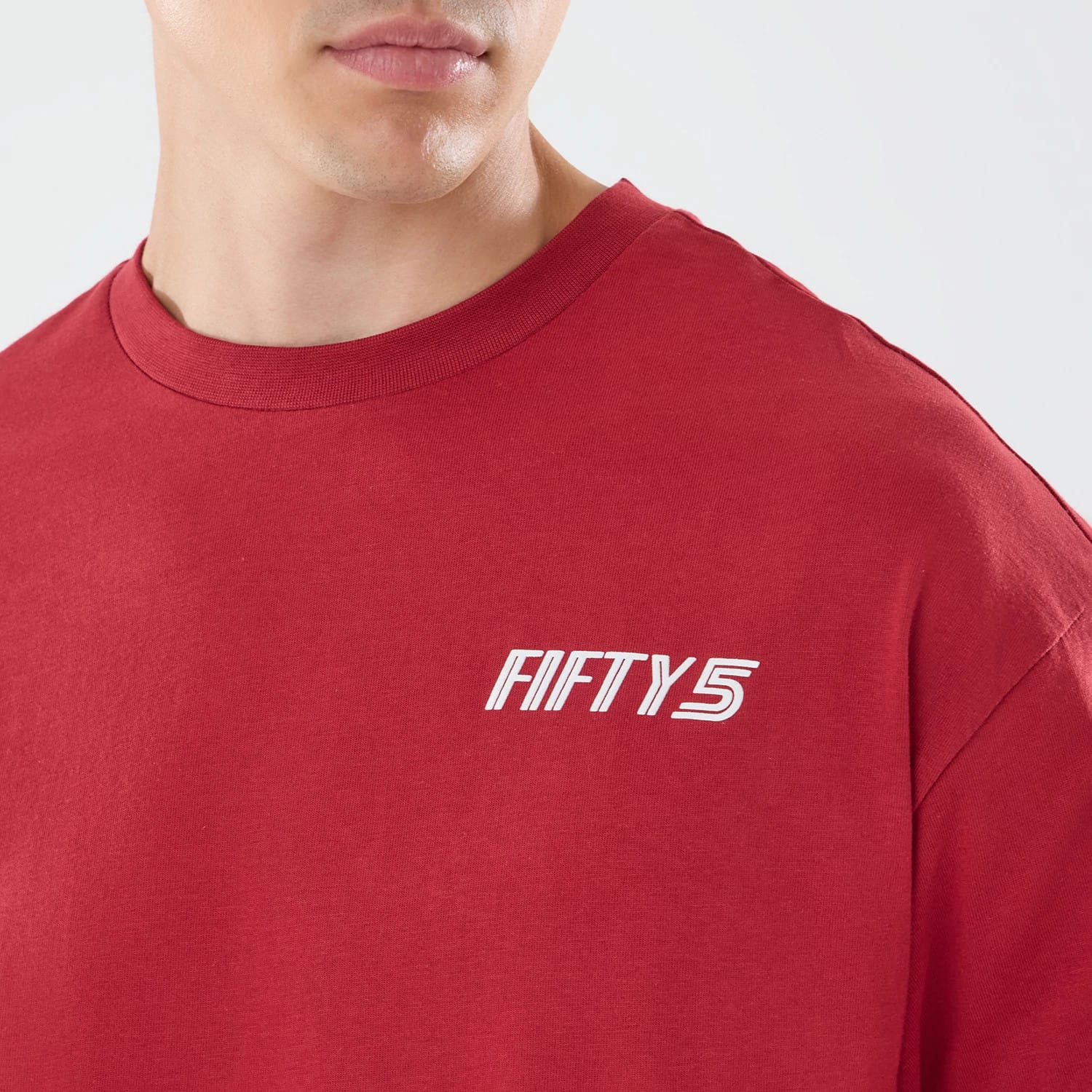 The model is wearing this Carlos Sainz Team Fifty5 Madrid Oversized T-Shirt in dark red. 4