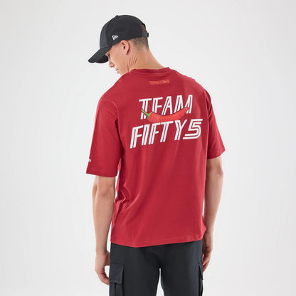 The model is wearing this Carlos Sainz Team Fifty5 Madrid Oversized T-Shirt in dark red. 2