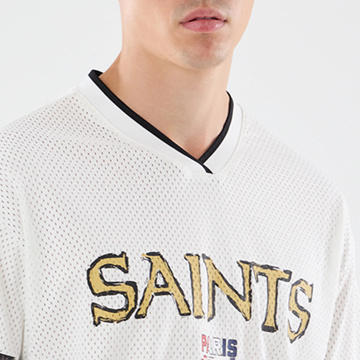 The model is wearing this NFL International Games 2026 Graphic New Orleans Saints Mesh Jersey in white. 3