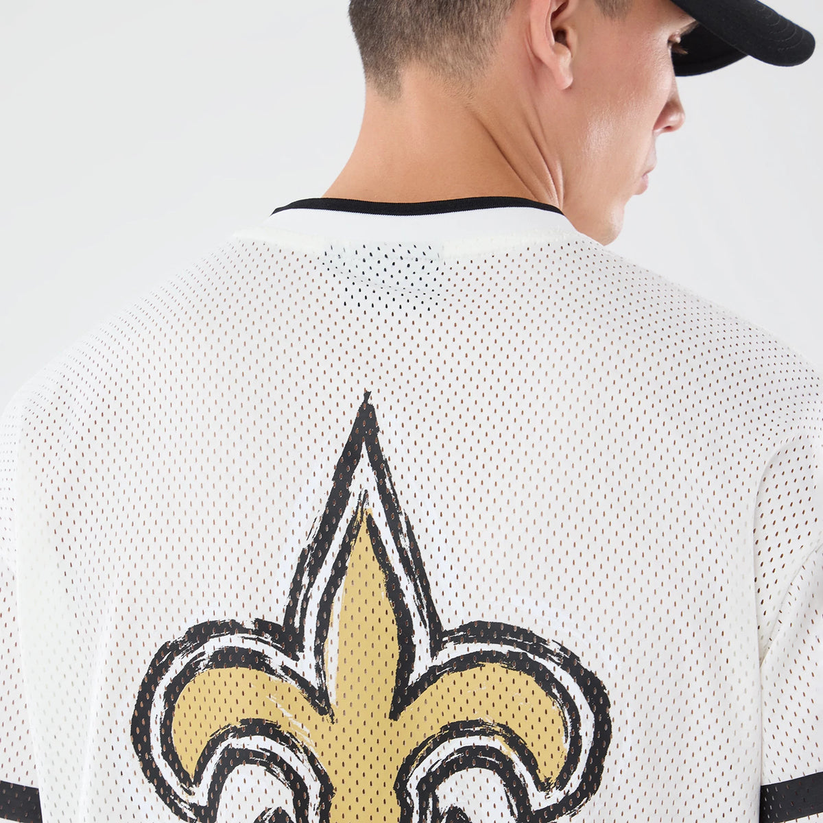 The model is wearing this NFL International Series Games 2026 Graphic New Orleans Saints Mesh Jersey in white. 7