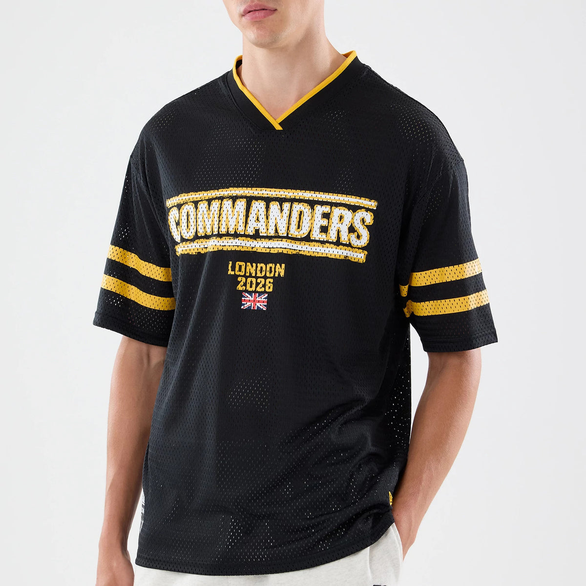 The model is wearing this NFL International Games 2026 Graphic Washington Commanders Mesh Jersey in black. 3