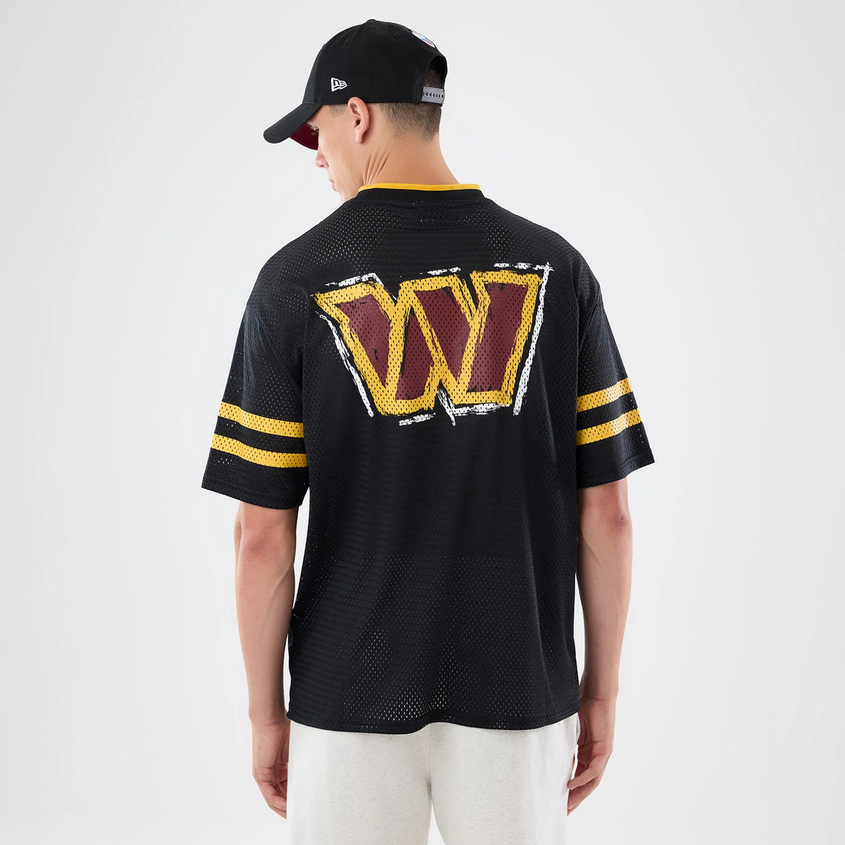The model is wearing this NFL International Series Games 2026 Graphic Washington Commanders Mesh Jersey in black. 2