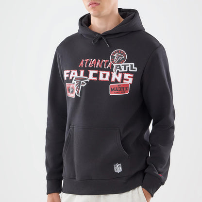 New Era Atlanta Falcons NFL Patch Black Pullover Hoodie, front view on-model featuring various embroidered patches, including the Atlanta Falcons logo and team name across the chest, a kangaroo pocket, and an NFL logo patch near the hem.