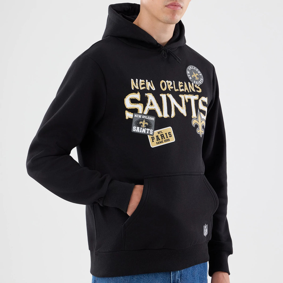 The model is wearing this NFL Patch New Orleans Saints Pullover Hoodie in black. 3