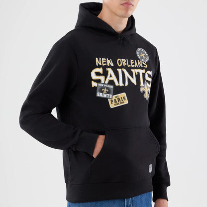 The model is wearing this NFL Patch New Orleans Saints Pullover Hoodie in black. 3