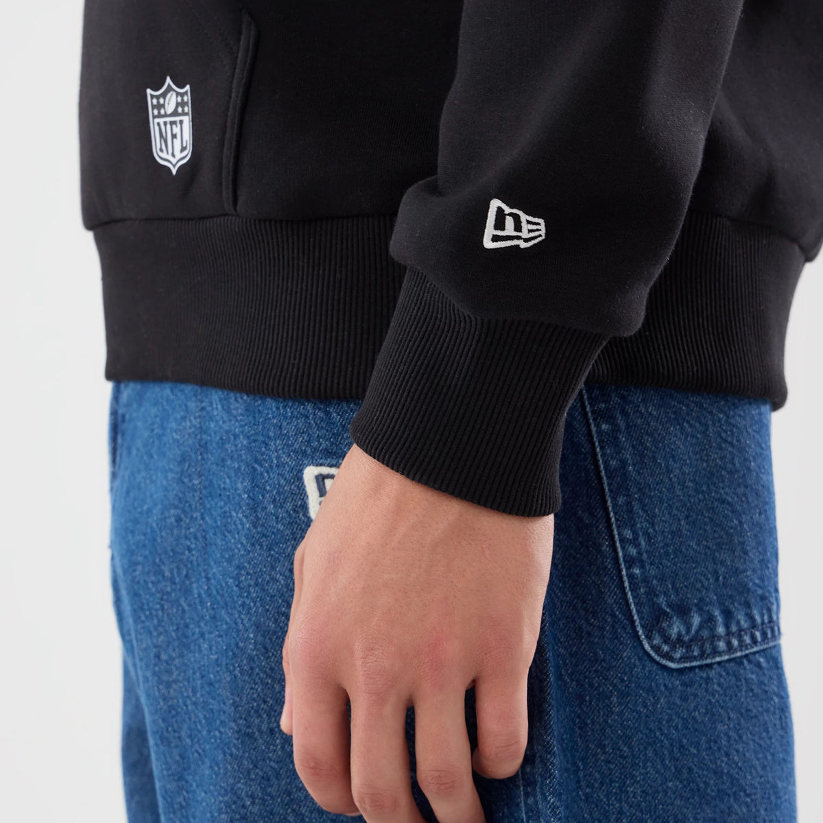 The model is wearing this NFL Patch New Orleans Saints Pullover Hoodie in black. 5