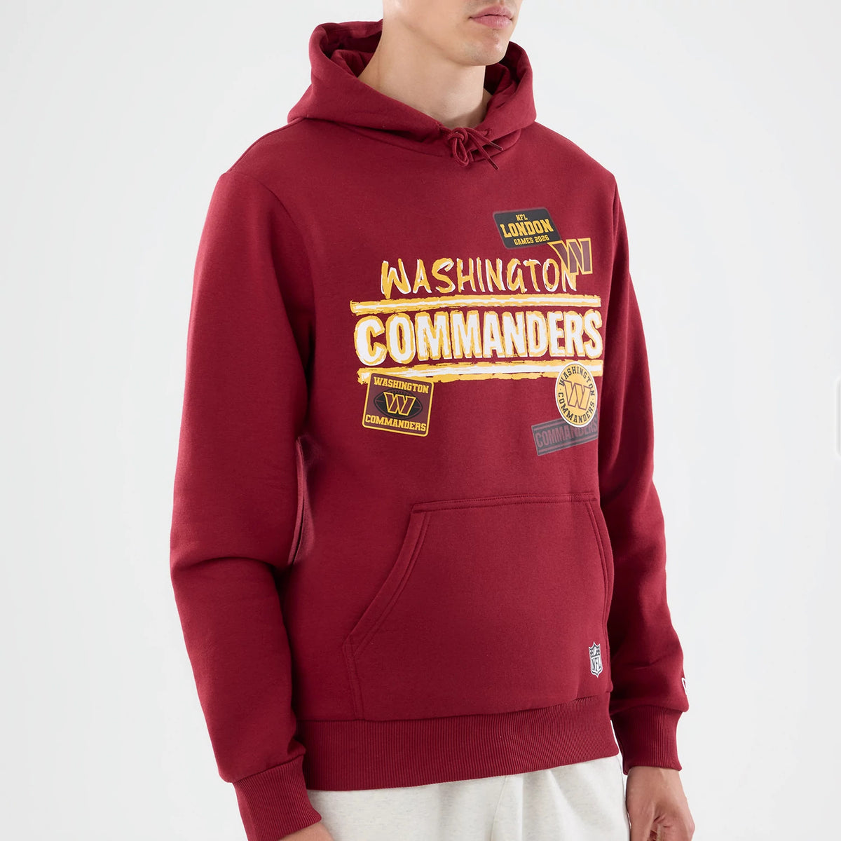 The model is wearing this NFL Patch Washington Commanders Pullover Hoodie in dark red. 4