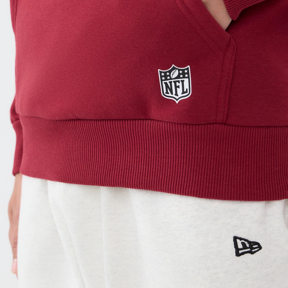 The model is wearing this NFL Patch Washington Commanders Pullover Hoodie in dark red. 7