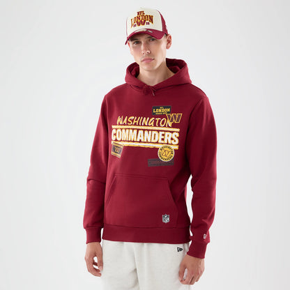 The model is wearing this NFL Patch Washington Commanders Pullover Hoodie in dark red. 1