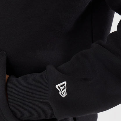 New Era Detroit Lions NFL Patch Black Pullover Hoodie, three-quarter view focused on the left sleeve featuring a white embroidered New Era logo near the ribbed cuff and a glimpse of the kangaroo pocket on the front of the hoodie.
