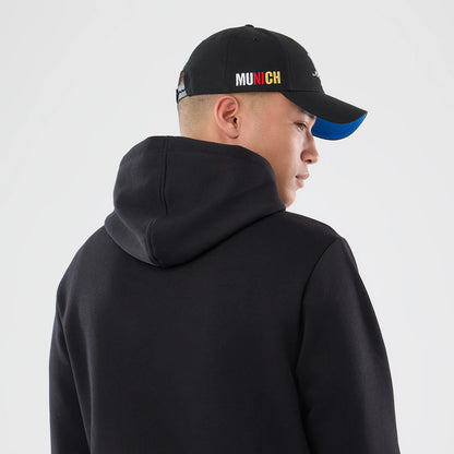 New Era Detroit Lions NFL Patch Black Pullover Hoodie, back view on a model styled with a black cap, displaying a black surface leading into a relaxed hood, creating a classic monochrome look with clean lines.