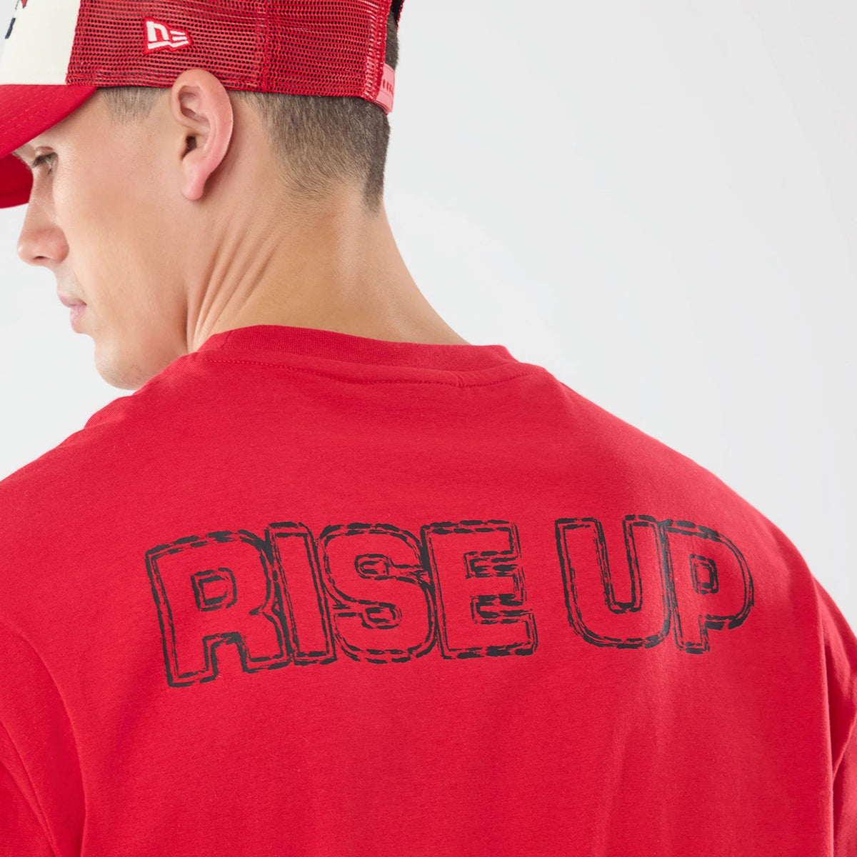 The model is wearing this NFL Graphic Slogan Atlanta Falcons Oversized T-Shirt in red. 5