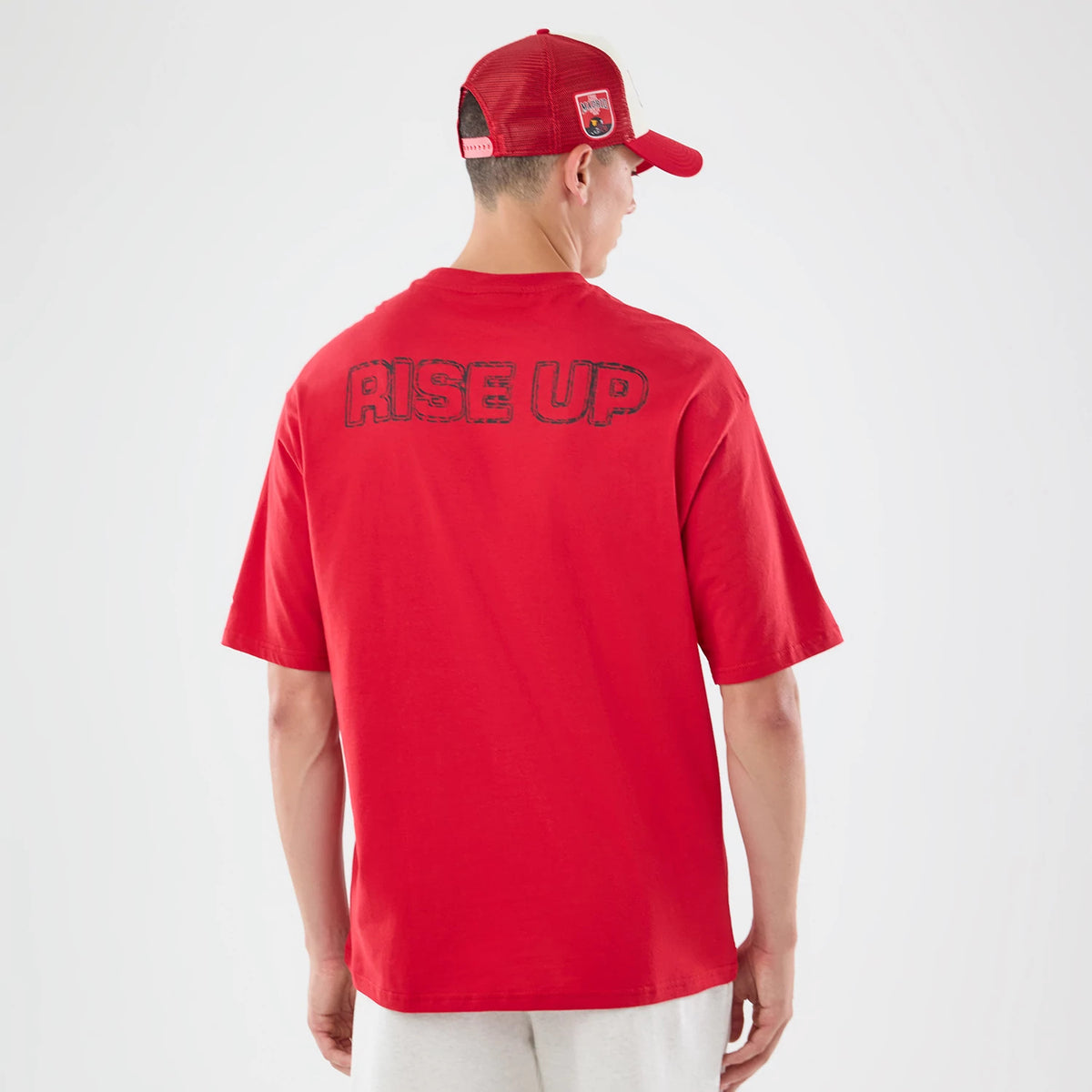 The model is wearing this NFL Graphic Slogan Atlanta Falcons Oversized T-Shirt in red. 2