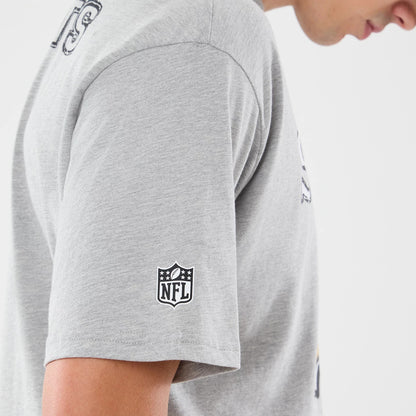 New Era New Orleans Saints NFL Graphic Slogan Grey Oversized T-Shirt, side view on a model showing the grey fabric with a printed NFL logo on the sleeve, view of a graphic slogan on the chest, and relaxed fit sleeve.