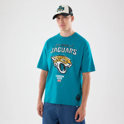 New Era Jacksonville Jaguars NFL Graphic Slogan Turquoise Oversized T-Shirt, front view on-model displaying large embroidered jaguar head below white Jacksonville Jaguars lettering, with London 2026 text and Union Jack flag detail near the bottom.