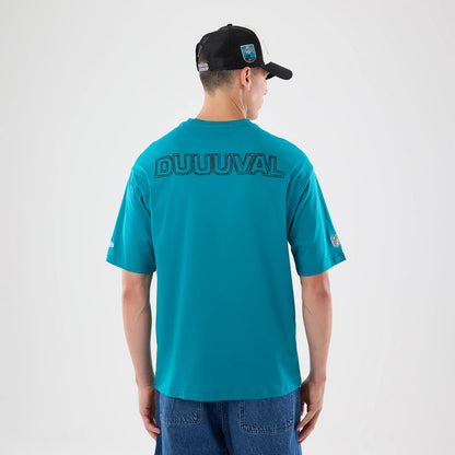 The model is wearing this NFL Graphic Slogan Jacksonville Jaguars Oversized T-Shirt in turquoise. 2