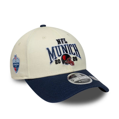 Pictured is this NFL International Series Games 2026 Munich New England Patriots 9FORTY M-Crown cap in white & dark blue. 1