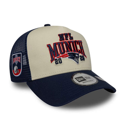 Pictured is this NFL International Series Games 2026 Munich New England Patriots 9FORTY A-Frame Trucker cap in dark blue. 1