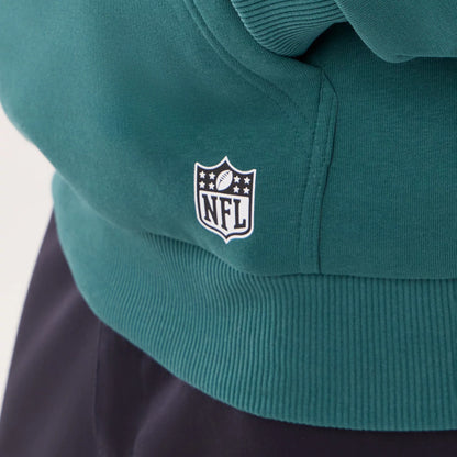 The model is wearing this NFL International Games 2026 Philadelphia Eagles Pullover Hoodie in dark green. 4