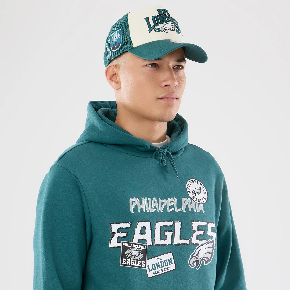 The model is wearing this NFL International Games 2026 Philadelphia Eagles Pullover Hoodie in dark green. 6