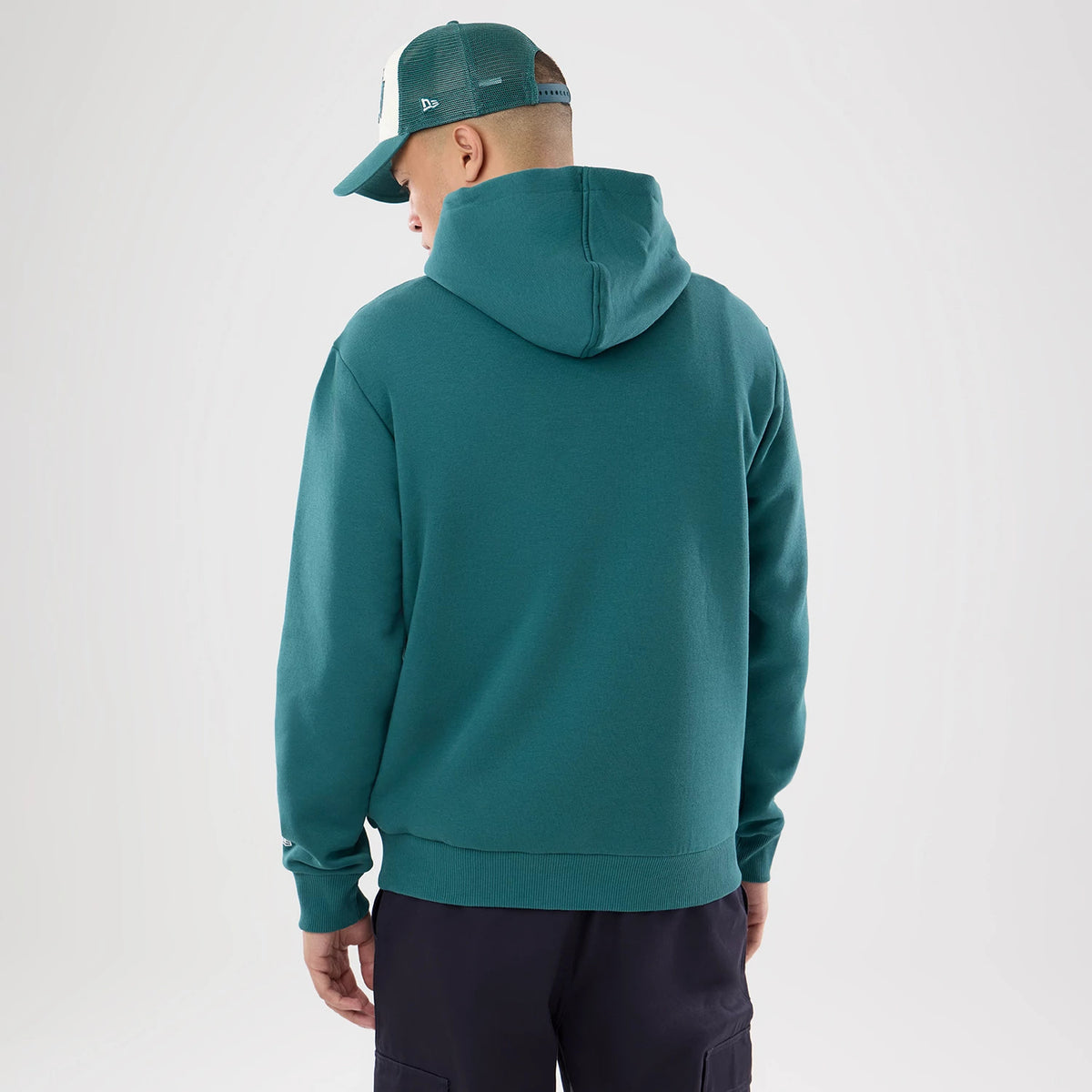 The model is wearing this NFL International Games 2026 Philadelphia Eagles Pullover Hoodie in dark green. 2