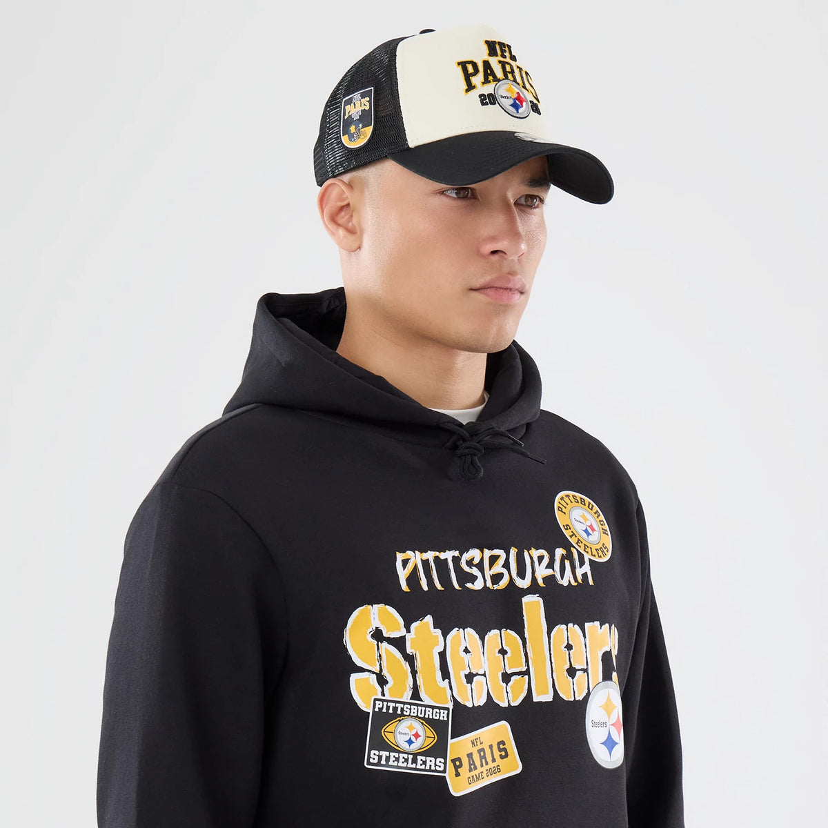 The model is wearing this NFL International Series Games 2026 Pittsburgh Steelers Pullover Hoodie in black. 6