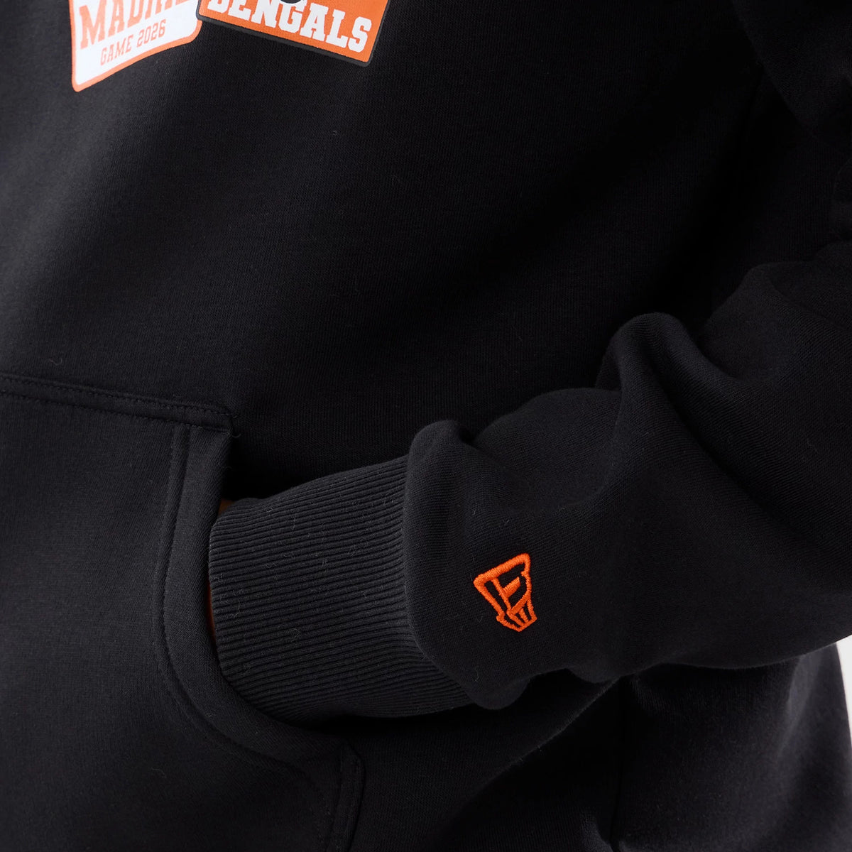 The model is wearing this NFL International Games 2026 Cincinnati Bengals Pullover Hoodie in black. 5