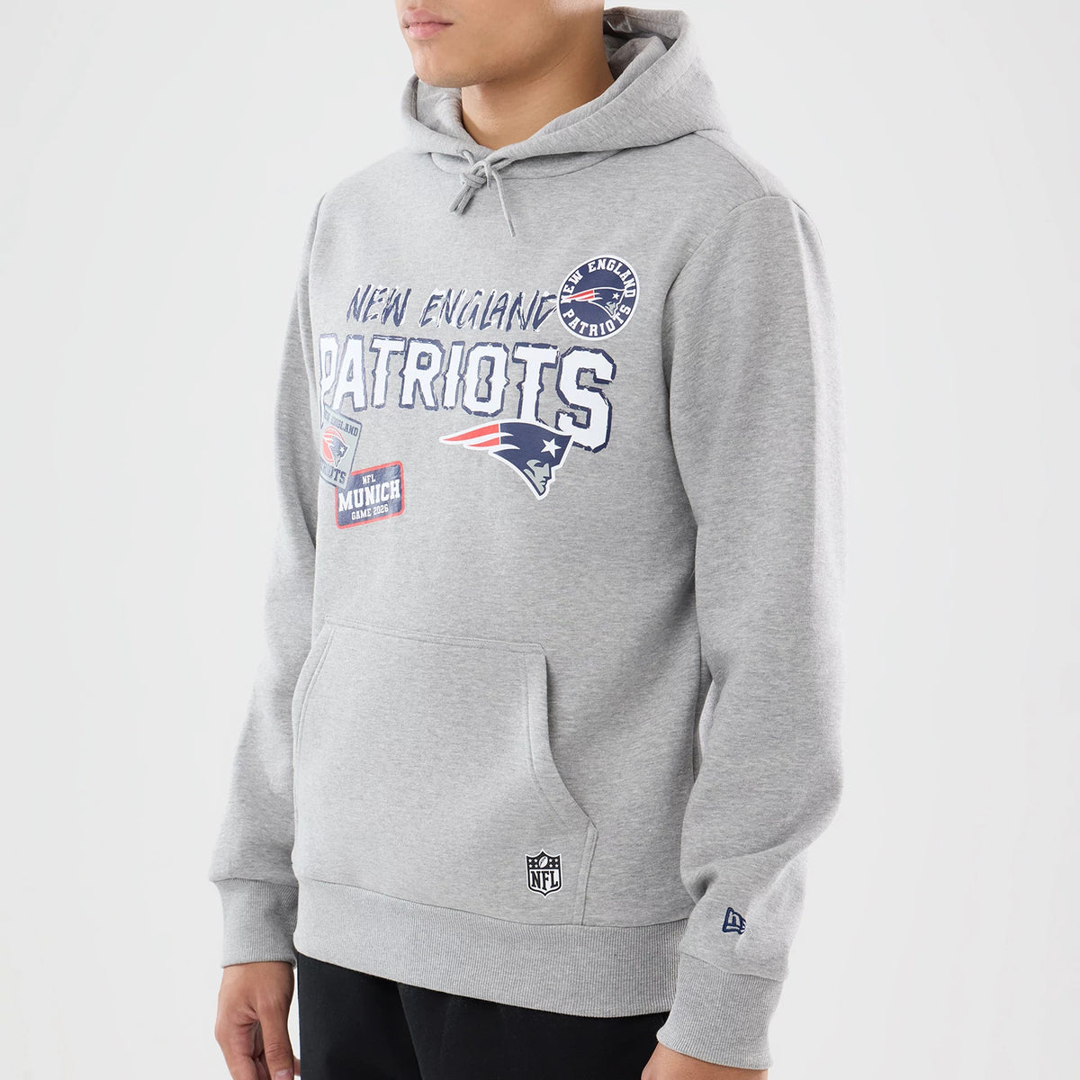 The model is wearing this NFL International Series Games 2026 New England Patriots Pullover Hoodie in grey. 3