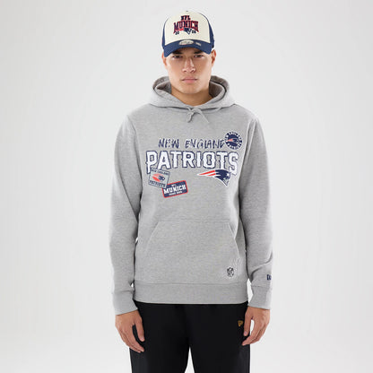 The model is wearing this NFL International Games 2026 New England Patriots Pullover Hoodie in grey. 1