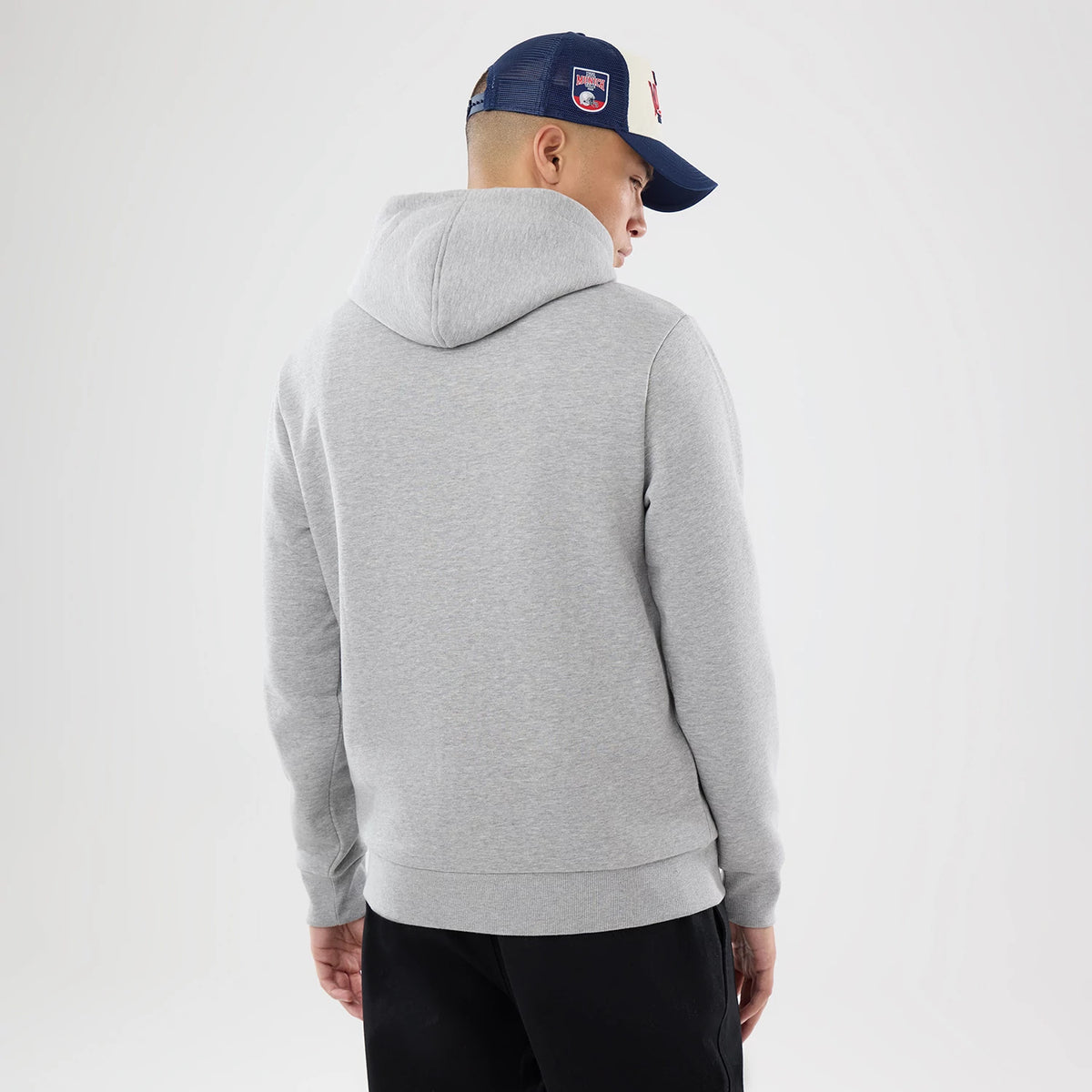 The model is wearing this NFL International Games 2026 New England Patriots Pullover Hoodie in grey. 2
