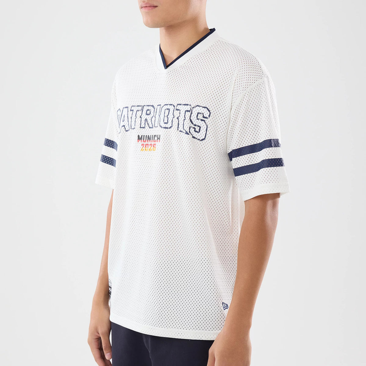 The model is wearing this NFL International Games 2026 New England Patriots Mesh Jersey in white. 3