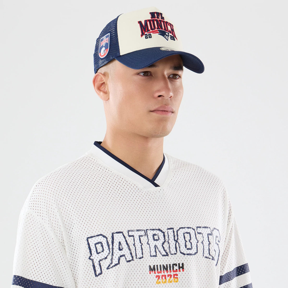 The model is wearing this NFL International Games 2026 New England Patriots Mesh Jersey in white. 6