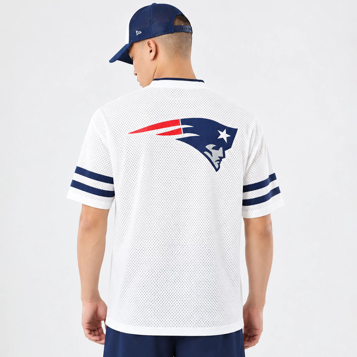 The model is wearing this NFL International Games 2026 New England Patriots Mesh Jersey in white. 2