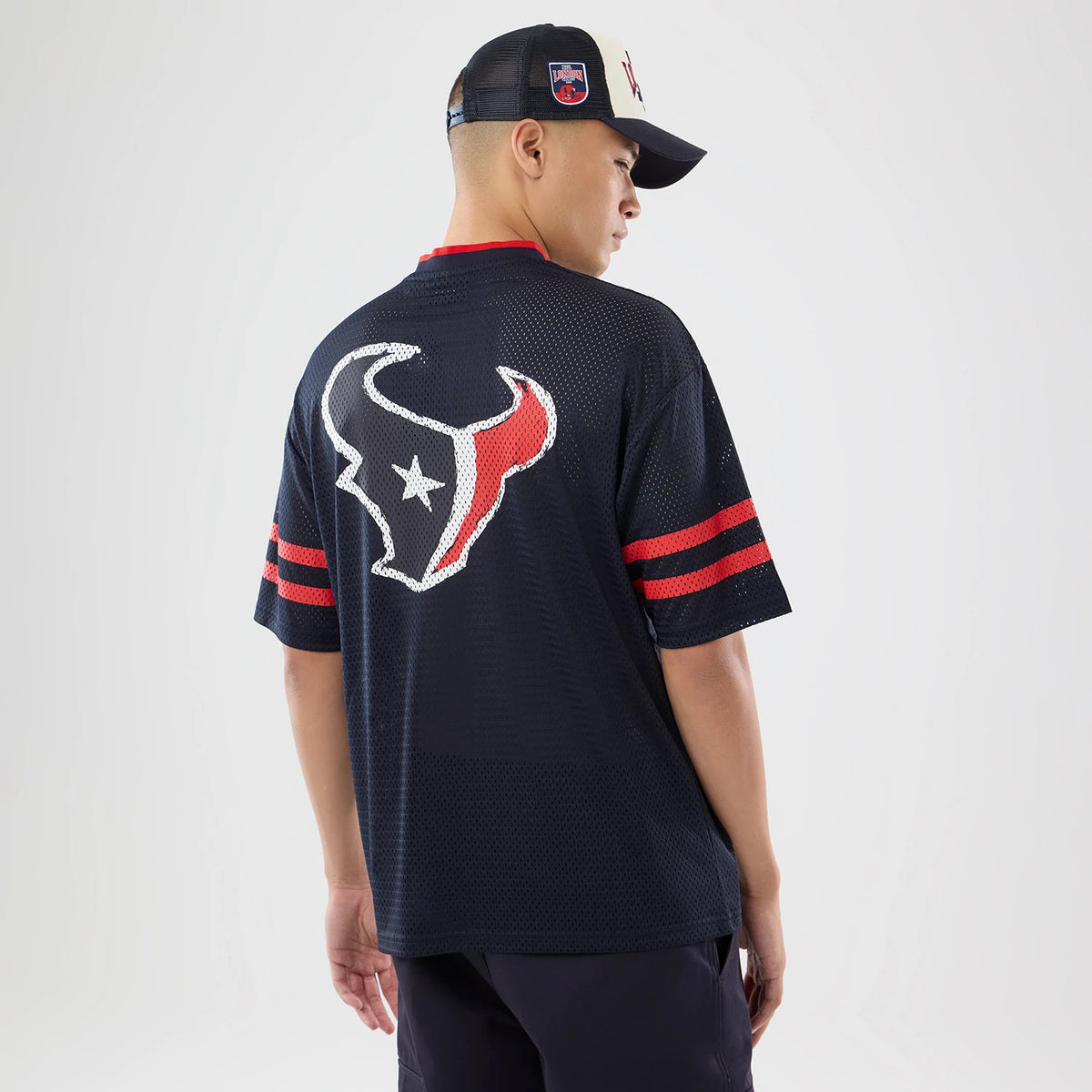 The model is wearing this NFL International Games 2026 Houston Texans Mesh Jersey in navy. 2