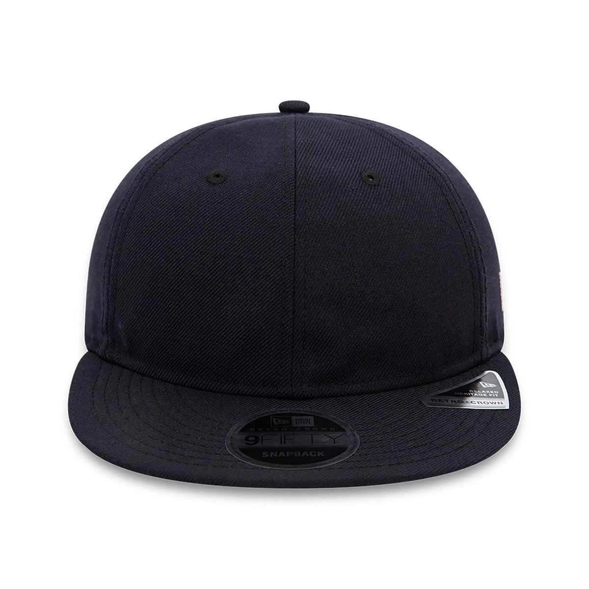 Blank New Era Navy Retro Crown 9FIFTY Snapback Cap, front view showing the plain navy front panel with eyelets, a flat navy visor adorned with a 9FIFTY size sticker, and a classic top button matching the crown colour.