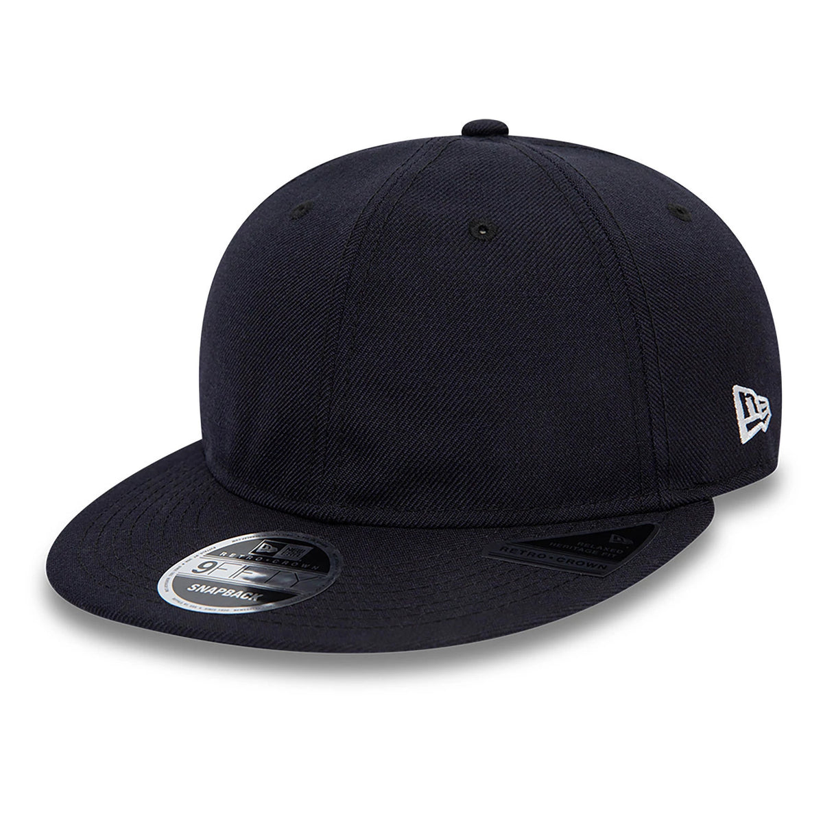 Blank New Era Navy Retro Crown 9FIFTY Snapback Cap, three-quarter view showing the navy structured crown, black flat visor with a 9FIFTY size sticker, and the white New Era flag logo embroidered on the left side.