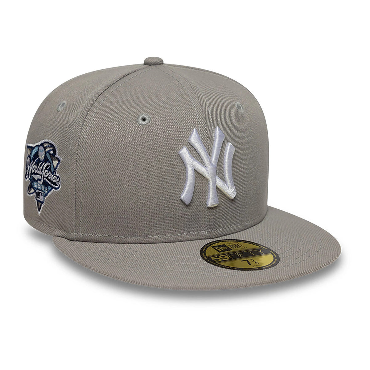 New York Yankees Essential Pack Grey & Blue New Era 59FIFTY Fitted Cap, three-quarter view showing the raised white embroidered NY logo on the front panel, grey flat visor with a gold 59FIFTY size sticker, and side World Series patch.