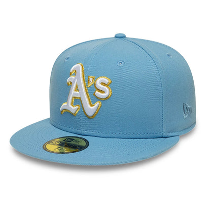Athletics MLB Pastel Blue New Era 59FIFTY Fitted Cap, three-quarter view showing the large white and gold embroidered A’s logo on the front panels, pastel blue flat visor with gold 59FIFTY size sticker, and New Era flag logo on the left side.